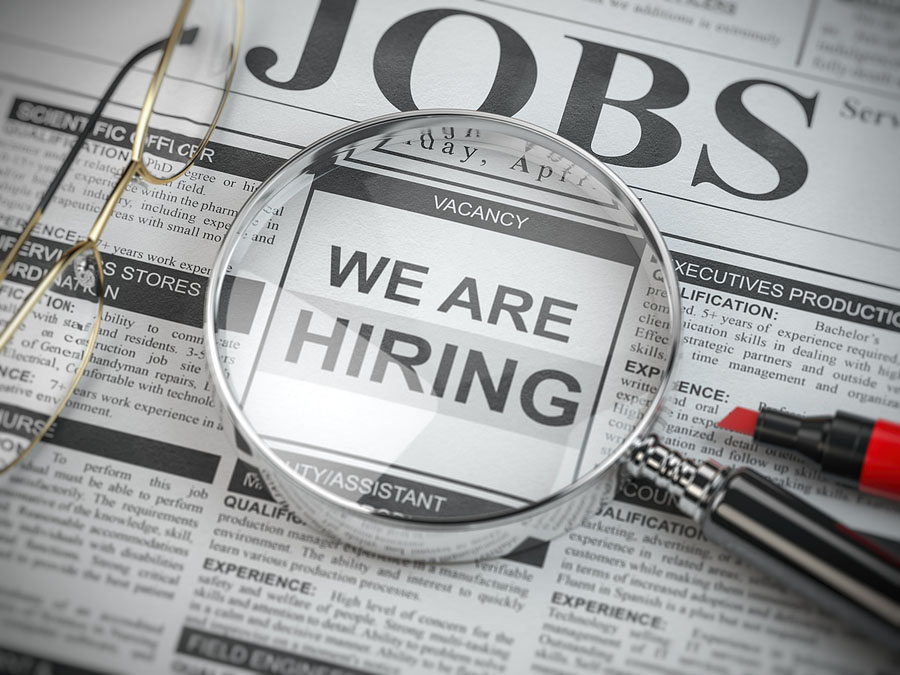 We are hiring. Job search and employment concept. Magnified glass with jobs classified ads in newspaper, 3d illustration